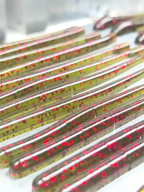 Ribbed straight-body soft plastics with red flake