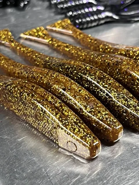 Brown soft plastics packed with gold-colored flake