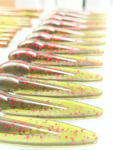 Translucent green soft plastics with red flake in rows