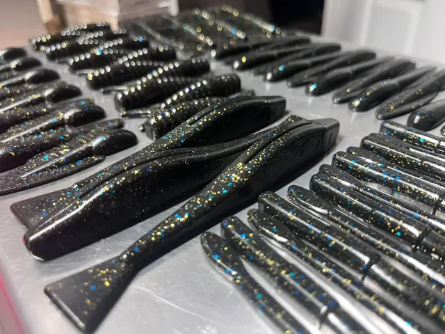 Dark soft plastics with several distinct tail shapes